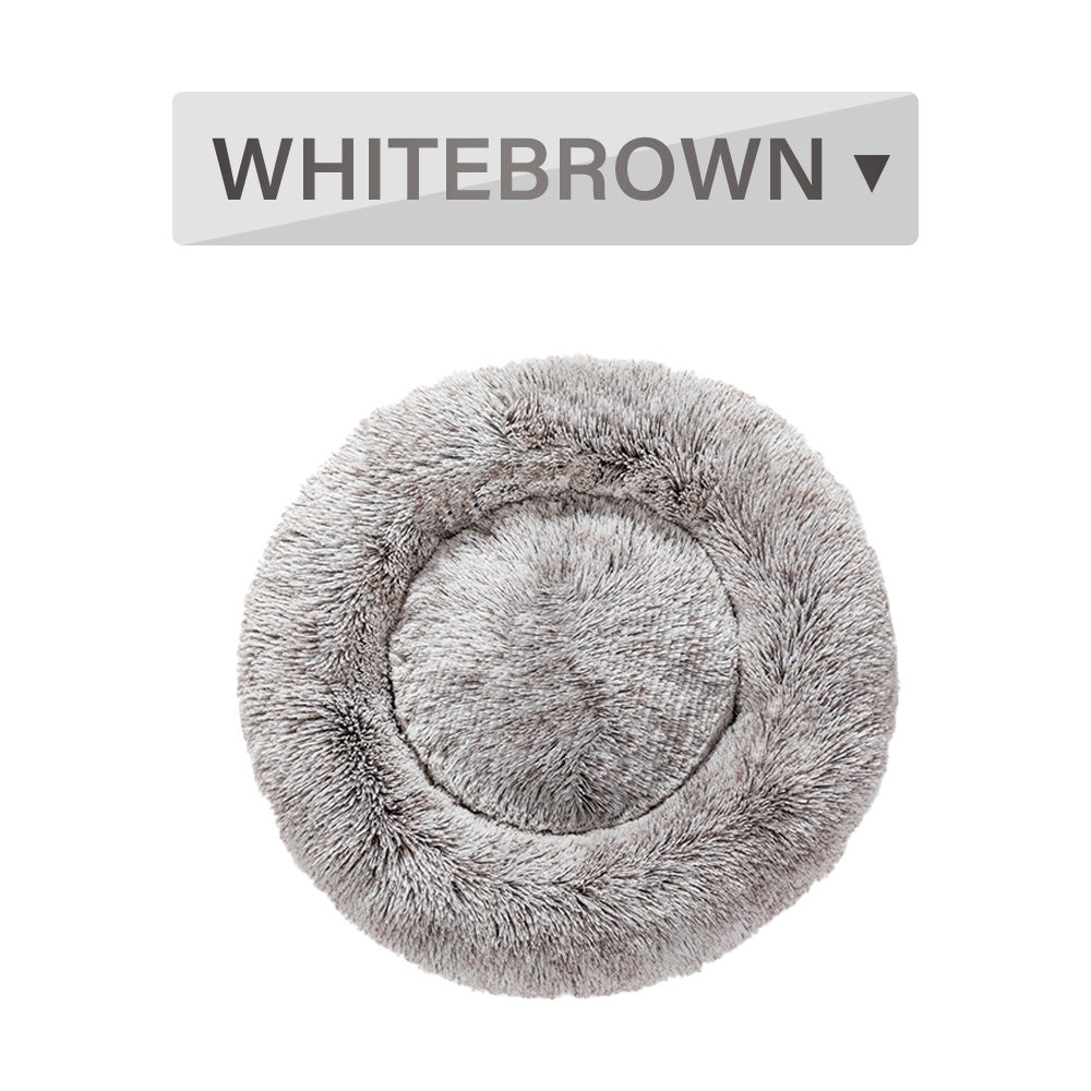 Soft, fluffy donut dog bed by Tangled Trails Outdoor Gear with warm, long plush cushioning for cozy pet comfort.