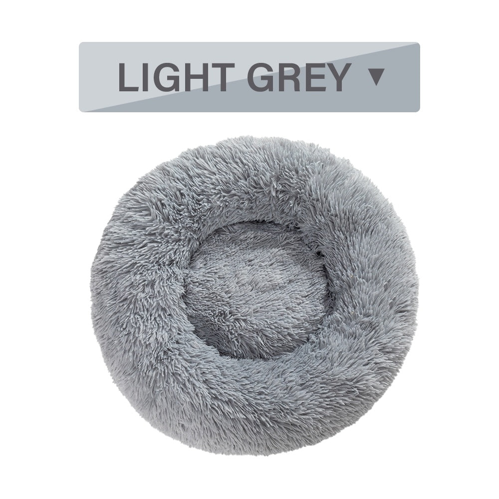 Soft, fluffy donut dog bed by Tangled Trails Outdoor Gear featuring warm, plush cushioning for cozy pet comfort.